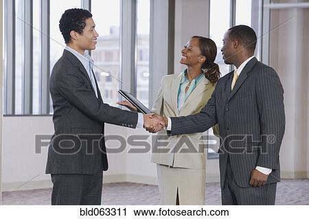 Multi-ethnic business people handshaking View Large Photo Image Stock Image - Multi-ethnic business people handshaking. Fotosearch
