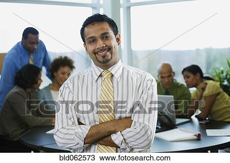 Stock Image - Multi-ethnic business people in meeting. Fotosearch