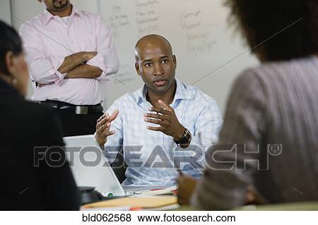 Stock Photo - Multi-ethnic business people in meeting. Fotosearch