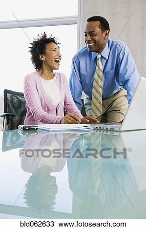Stock Image - Multi-ethnic business people laughing. Fotosearch