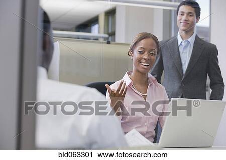Stock Image - Multi-ethnic business people meeting in office. Fotosearch