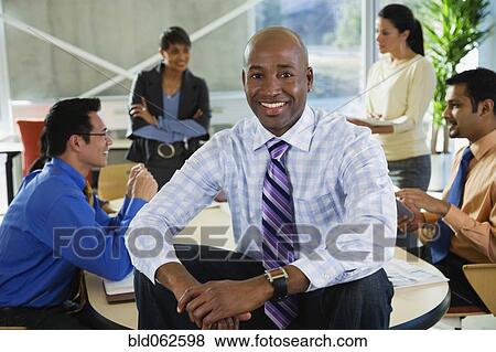Stock Photo - Multi-ethnic business people meeting in office. Fotosearch