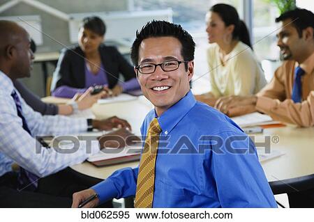 Stock Photography - Multi-ethnic business people meeting in office. Fotosearch