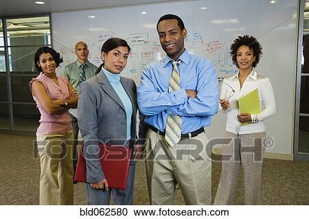 Stock Image - Multi-ethnic business people posing in office. Fotosearch