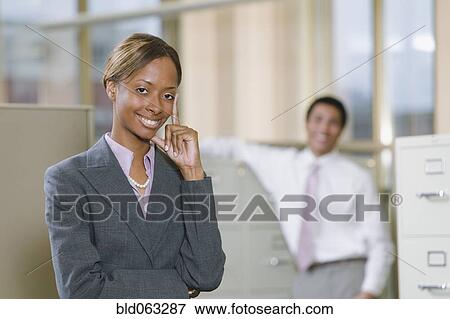 Multi-ethnic business people posing in office View Large Photo Image Stock Photo - Multi-ethnic business people posing in office. Fotosearch
