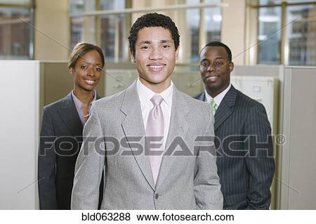 Stock Photo - Multi-ethnic business people posing in office. Fotosearch