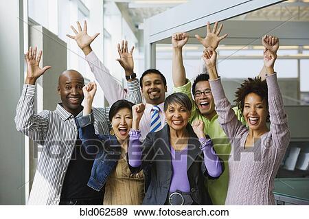 Stock Photo - Multi-ethnic business people celebrating in office. Fotosearch