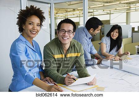 Multi-ethnic business people working in office View Large Photo Image Picture - Multi-ethnic business people working in office. Fotosearch