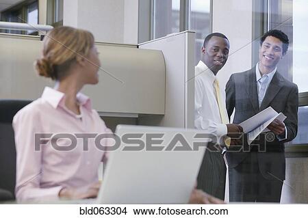 Picture - Multi-ethnic business people working together in office. Fotosearch