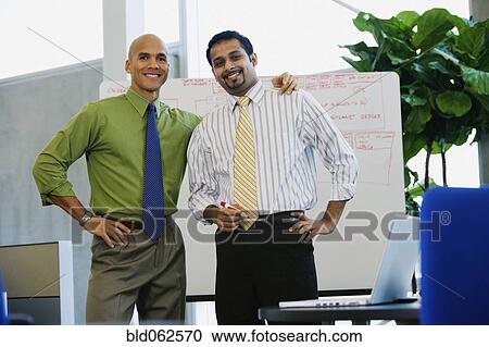 Multi-ethnic businessmen looking confident in office View Large Photo Image Stock Image - Multi-ethnic businessmen looking confident in office. Fotosearch