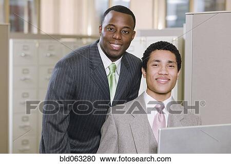 Multi-ethnic businessmen posing in office View Large Photo Image Stock Image - Multi-ethnic businessmen posing in office. Fotosearch