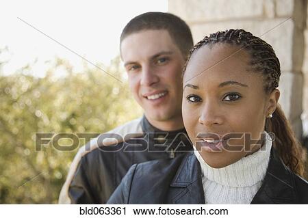 Stock Image - Multi-ethnic couple on balcony. Fotosearch