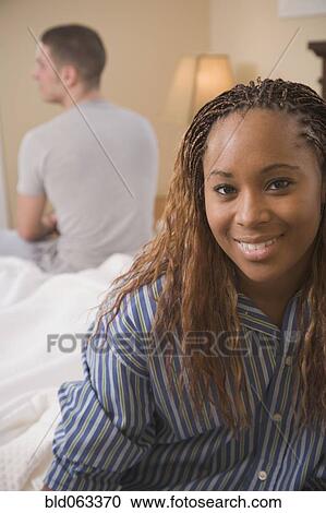 Multi-ethnic couple sitting on opposite edges of bed View Large Photo Image Stock Image - Multi-ethnic couple sitting on opposite edges of bed. Fotosearch