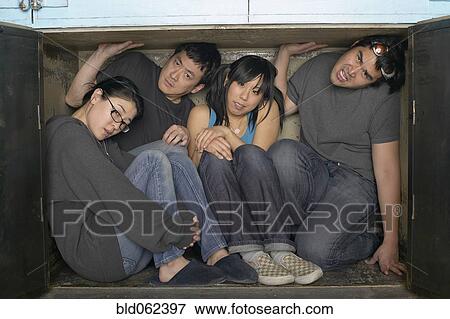 Stock Photo - Multi-ethnic group squeezed in small space. Fotosearch