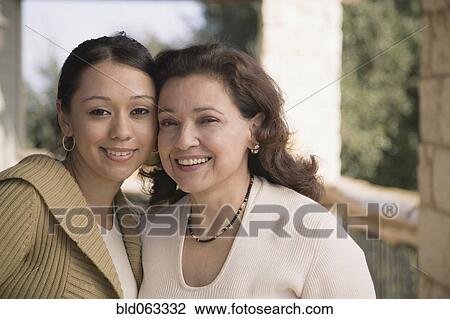 Stock Image - Multi-ethnic mother and daughter smiling. Fotosearch