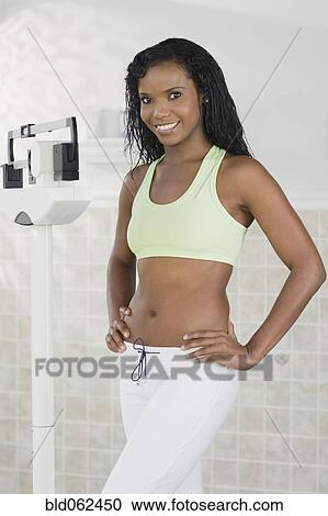Panamanian woman standing on scale View Large Photo Image Stock Image - Panamanian woman standing on scale. Fotosearch