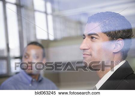 Two businessman behind window glass View Large Photo Image Stock Photography - Two businessman behind window glass. Fotosearch