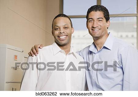 Stock Image - Two businessmen smiling. Fotosearch
