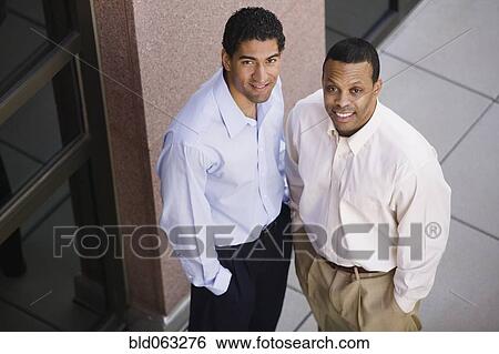Two businessmen smiling View Large Photo Image Stock Photograph - Two businessmen smiling. Fotosearch