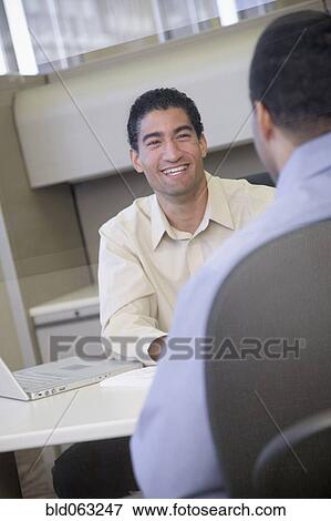 Stock Photo - Two businessmen working in office. Fotosearch