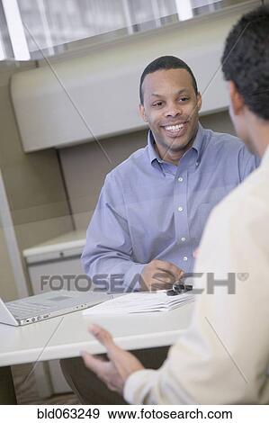Stock Photo - Two businessmen working in office. Fotosearch