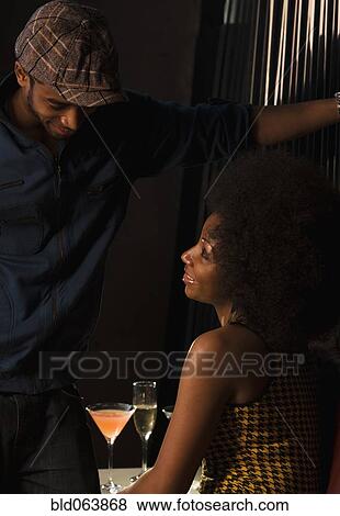 Stock Photo - African couple drinking in nightclub. Fotosearch