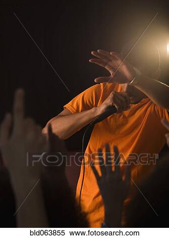 Stock Photography - African man singing to audience. Fotosearch