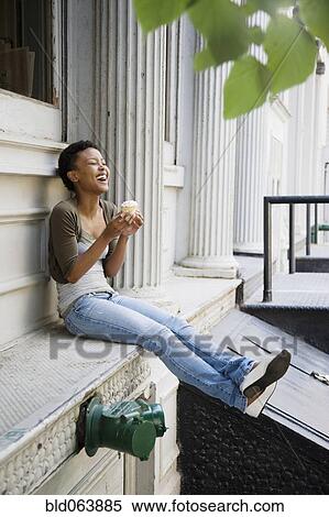 African woman eating cupcake outdoors View Large Photo Image Stock Photography - African woman eating cupcake outdoors. Fotosearch