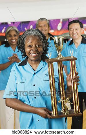 African woman holding bowling trophy View Large Photo Image Picture - African woman holding bowling trophy. Fotosearch