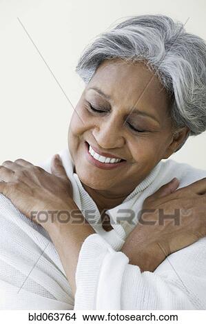 Picture - African woman in with eyes closed. Fotosearch