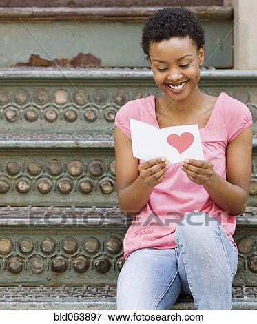 African woman reading Valentine’s Day card View Large Photo Image Stock Photo - African woman reading Valentine’s Day card. Fotosearch