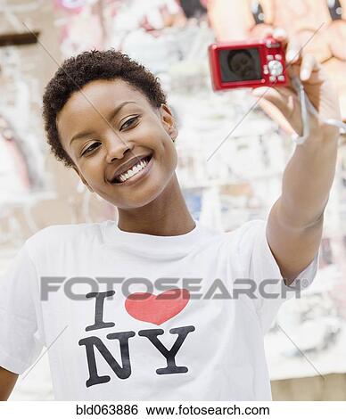 African woman taking self-portrait with digital camera View Large Photo Image Stock Photograph - African woman taking self-portrait with digital camera. Fotosearch