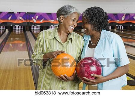 African women holding bowling balls in bowling alley View Large Photo Image Stock Photo - African women holding bowling balls in bowling alley. Fotosearch