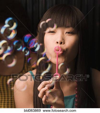 Asian woman blowing bubbles View Large Photo Image Stock Photo - Asian woman blowing bubbles. Fotosearch