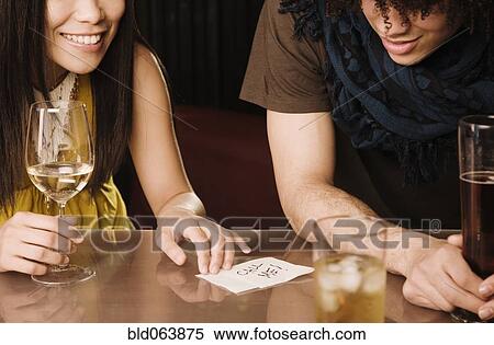 Asian woman giving mixed race man her phone number in nightclub View Large Photo Image Stock Photography - Asian woman giving mixed race man her phone number in nightclub. Fotosearch