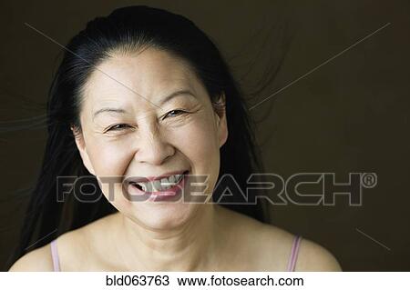 Stock Image - Asian woman laughing. Fotosearch