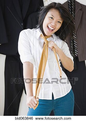 Stock Photograph - Asian woman wearing men’s necktie. Fotosearch