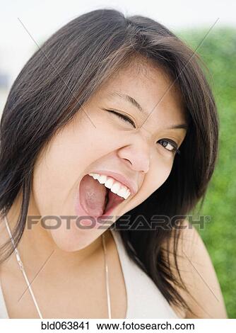 Asian woman winking View Large Photo Image Stock Image - Asian woman winking. Fotosearch