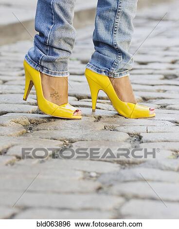 Close up of African woman wearing yellow high heels View Large Photo Image Stock Photograph - Close up of African woman wearing yellow high heels. Fotosearch