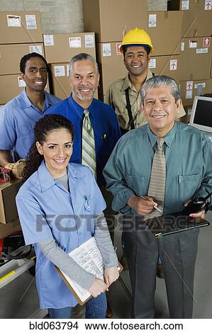 Picture - Co-workers in shipping office. Fotosearch