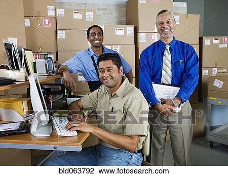 Co-workers in shipping office View Large Photo Image Stock Image - Co-workers in shipping office. Fotosearch