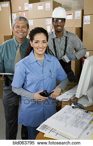 Stock Photography - Co-workers in shipping office. Fotosearch