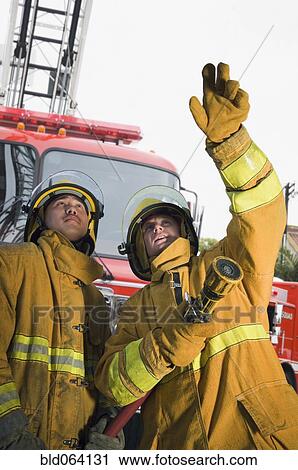 Firefighters putting out fire View Large Photo Image Stock Image - Firefighters putting out fire. Fotosearch
