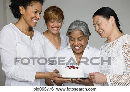 Friends surprising African woman with birthday cake View Large Photo Image Stock Photograph - Friends surprising African woman with birthday cake. Fotosearch