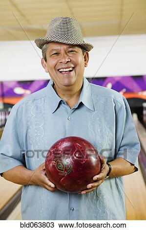 Hispanic man holding bowling ball View Large Photo Image Stock Image - Hispanic man holding bowling ball. Fotosearch