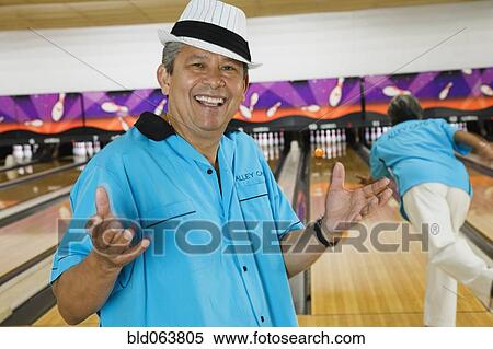 Hispanic man in bowling alley View Large Photo Image Stock Photography - Hispanic man in bowling alley. Fotosearch