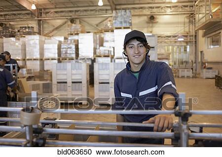 Hispanic man working in bottling factory View Large Photo Image Stock Image - Hispanic man working in bottling factory. Fotosearch