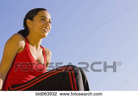 Stock Image - Hispanic woman in sportswear outdoors. Fotosearch