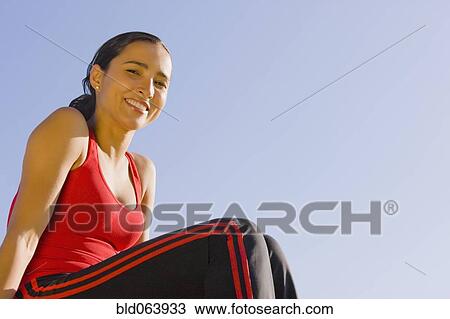 Stock Image - Hispanic woman in sportswear outdoors. Fotosearch