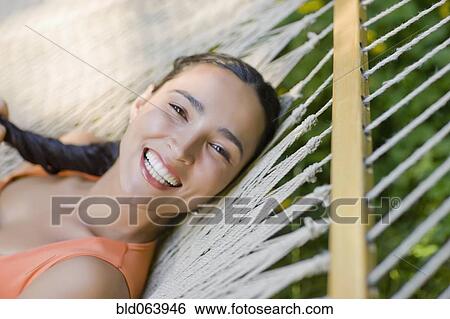 Hispanic woman laying in hammock View Large Photo Image Stock Photograph - Hispanic woman laying in hammock. Fotosearch